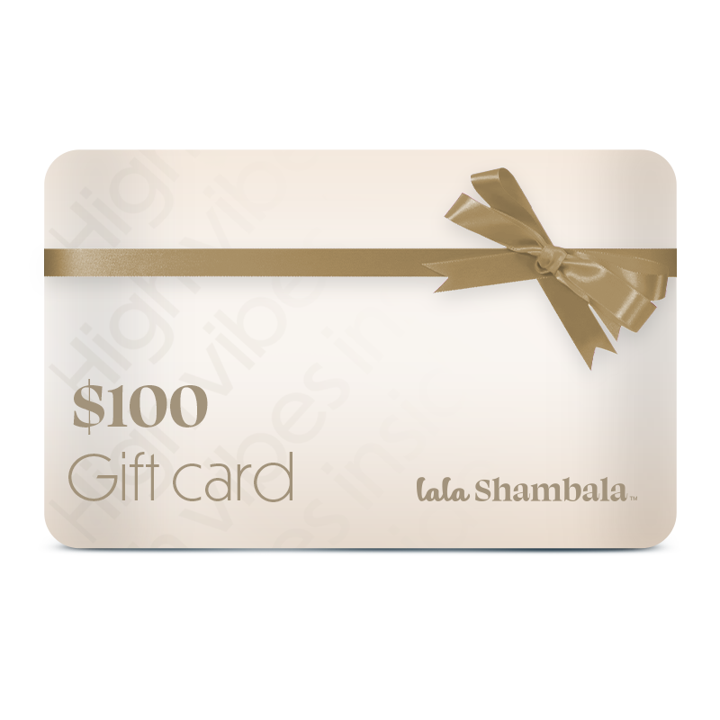A Lala Shambala gift card in denomination of $100. The card is cream with a bronze ribbon and features the Lala Shambala logo in the bottom right corner and amount on the left.