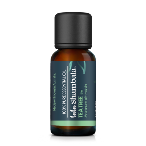 Tea Tree Pure Essential Oil in a glass amber bottle with a blue label and light green accents. The Lala Shambala logo is featured at the front.